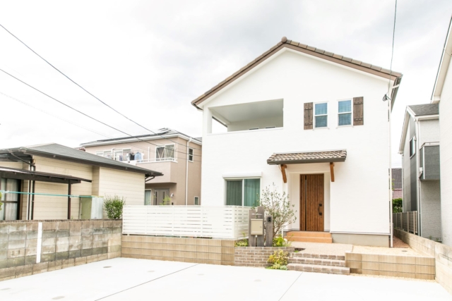 屋根や飾り窓、玄関ドアなど統一感のある色合いや、全体の雰囲気に合わせた素敵なお庭まわりが特徴的な外観。